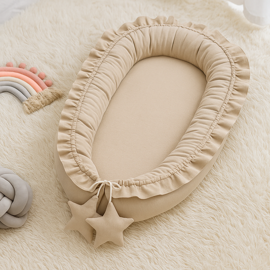 Réducteur de lit bébé Rêve de Lin beige posé sur un tapis doux, présenté en ambiance chaleureuse dans une chambre de bébé